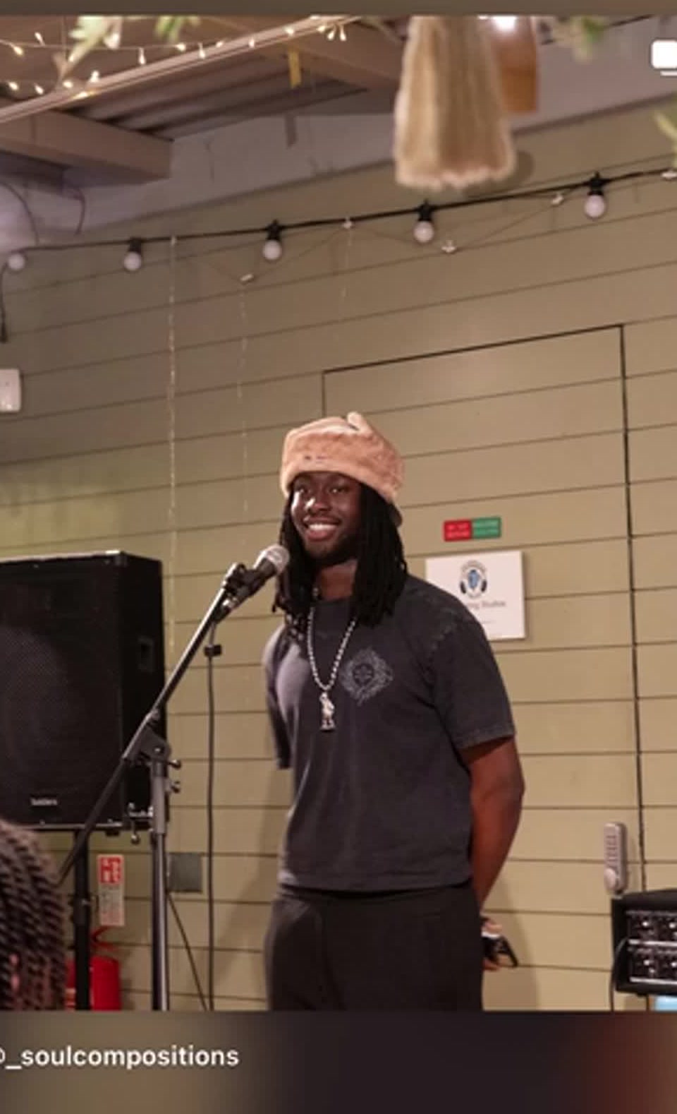 KAYZ performing spoken word, mic in hand